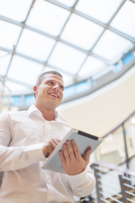 Smiling Man With Tablet Computer